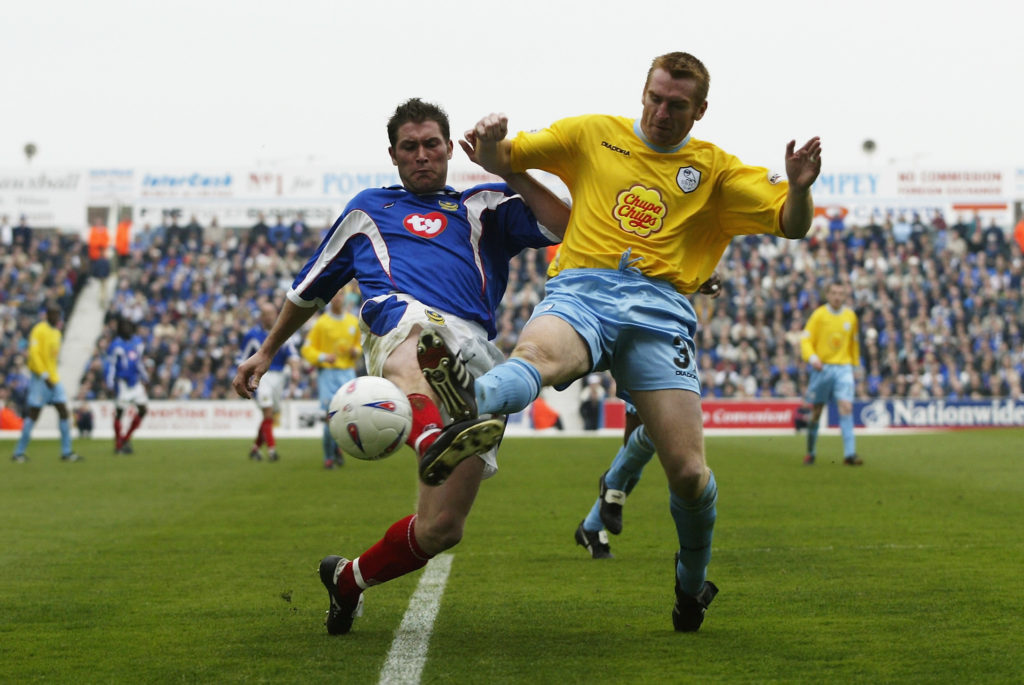 Lee Bradbury of Portsmouth challenges Dean Smith of Sheffield Wednesday for the ball